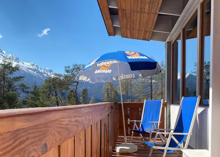 Terrazza in legno con sedie prendisole